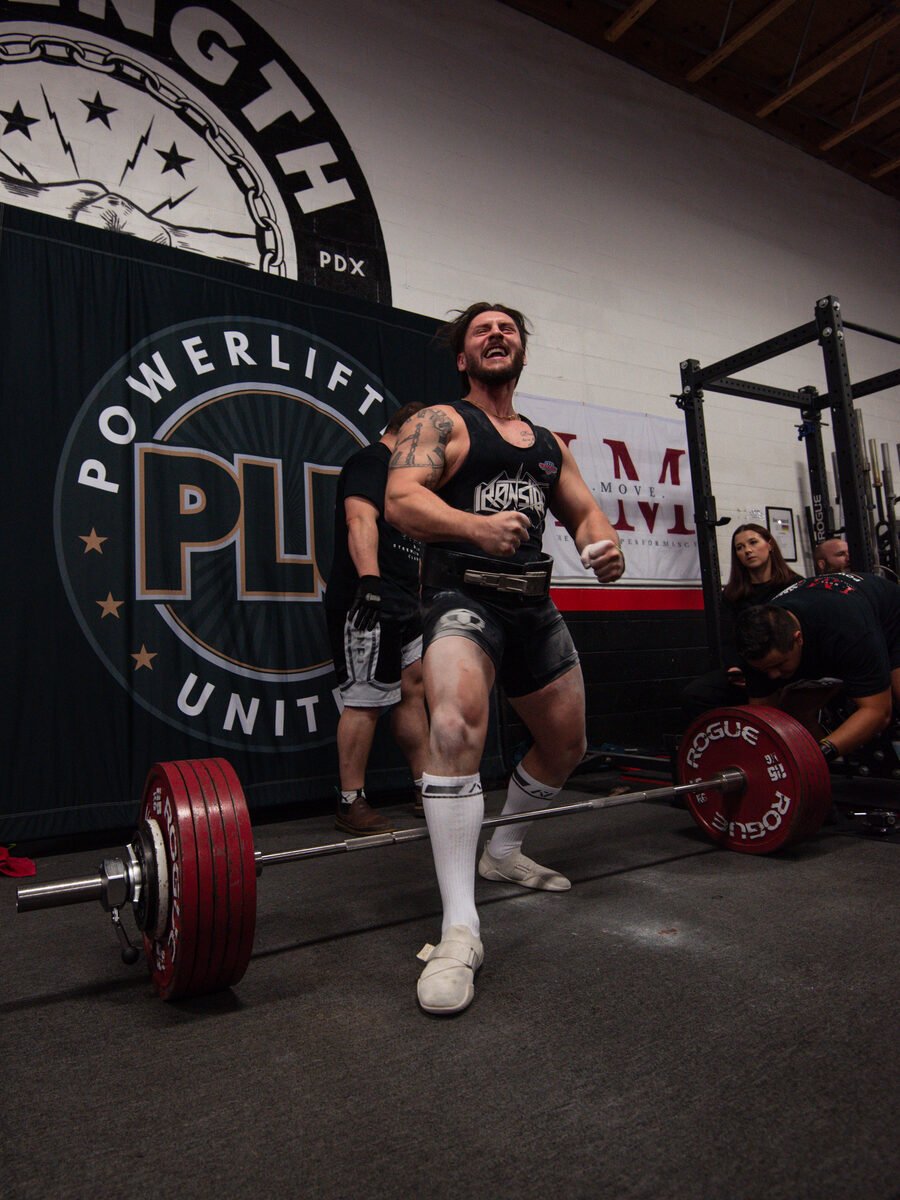 An athlete coached by Ardell locking out a competition deadlift