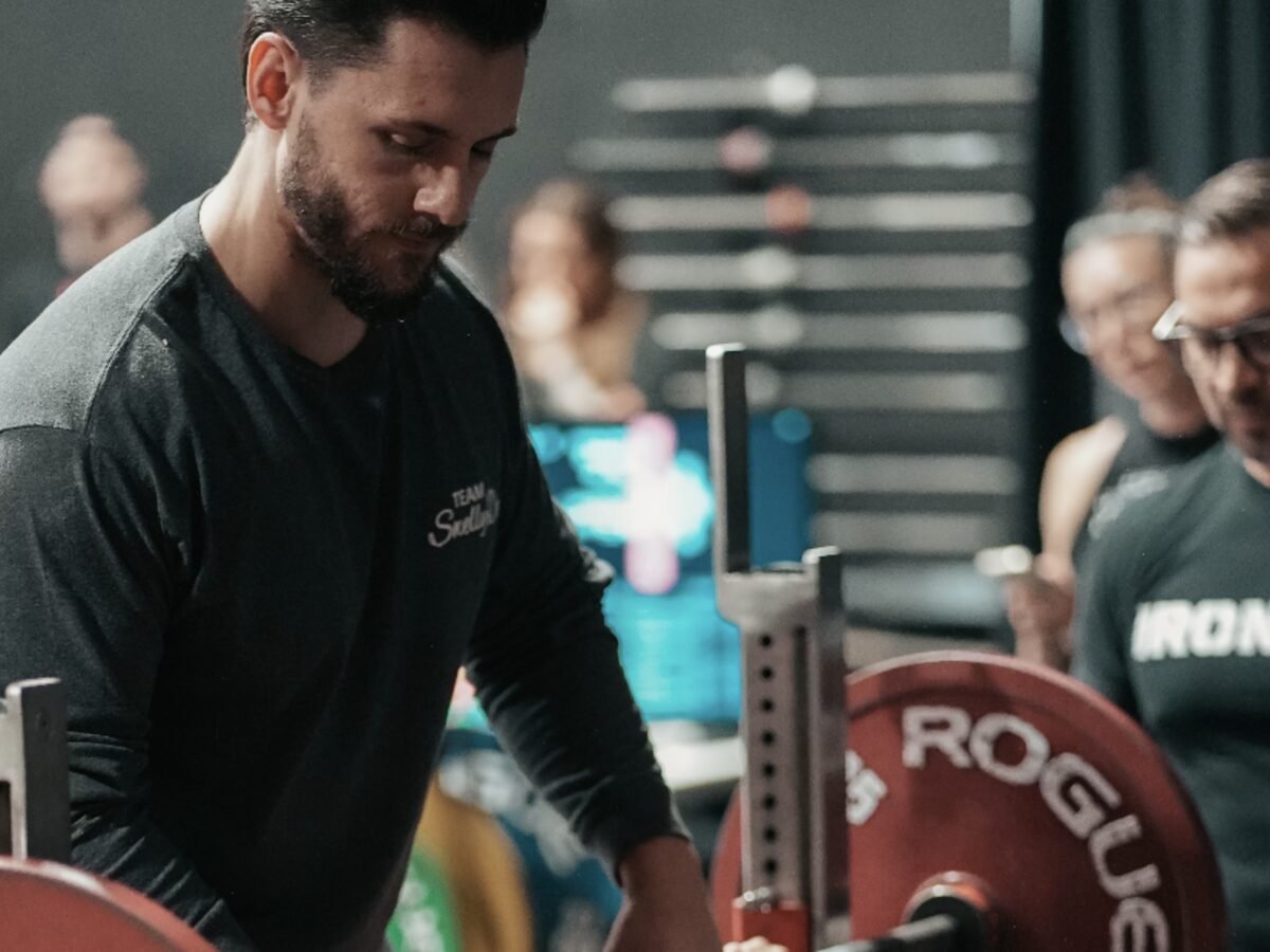 Hands-on Swelly Delly coaching at the bench press during a Powerlifting United meet
